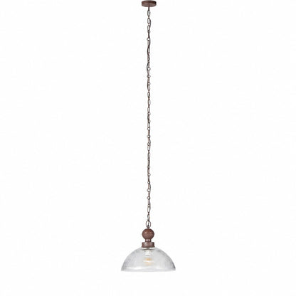 Full length view of long rust chain dropping from ceiling to fluted glass dome