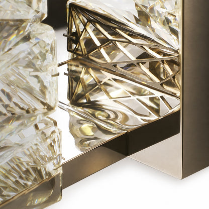 Close detail of brass-toned geometric lattice frame visible behind clear crystal blocks