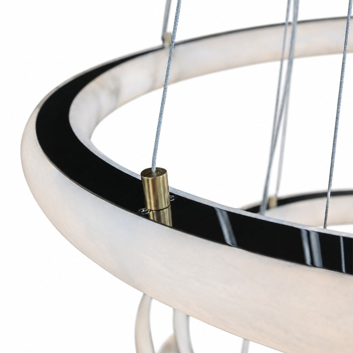 Close-up of alabaster hoop edge with brass cable connector and steel suspension wires