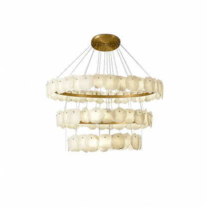 Three stacked rings of translucent ivory stone panels hung from thin cables, studio white backdrop